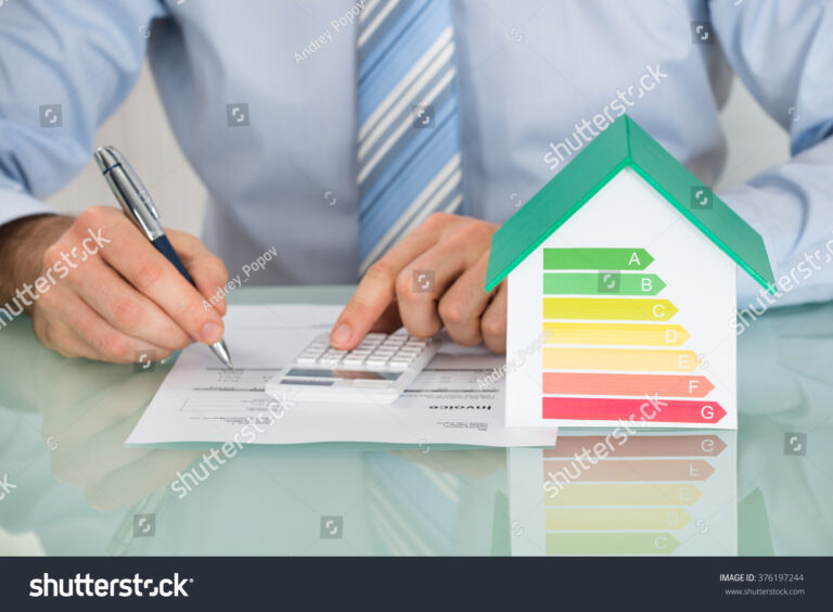 stock-photo-close-up-of-businessman-calculating-energy-efficiency-rate-of-house-in-office-376197244